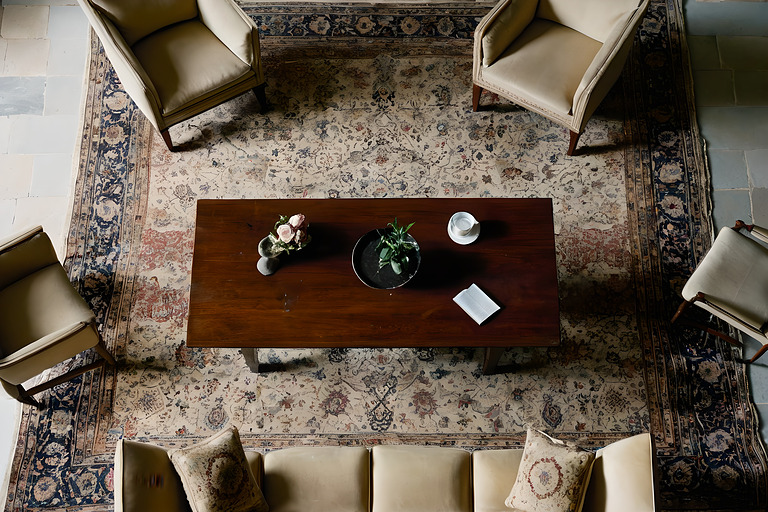 Overhead view of a seating group standing on a large patterned rug